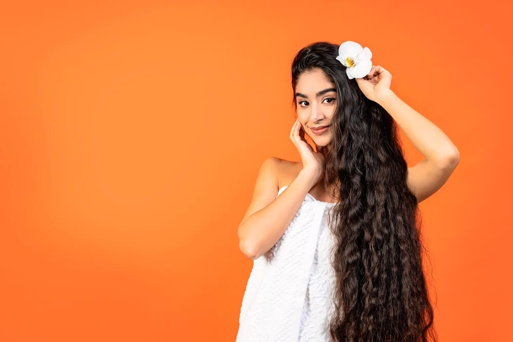 A woman adorning long, healthy and strong hair achieved through hair spa treatments.