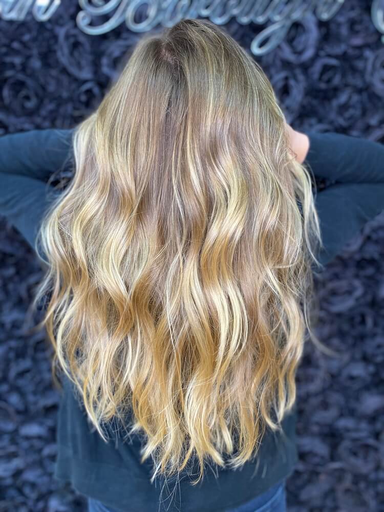 A woman showing off her beautiful dirty blonde curls.