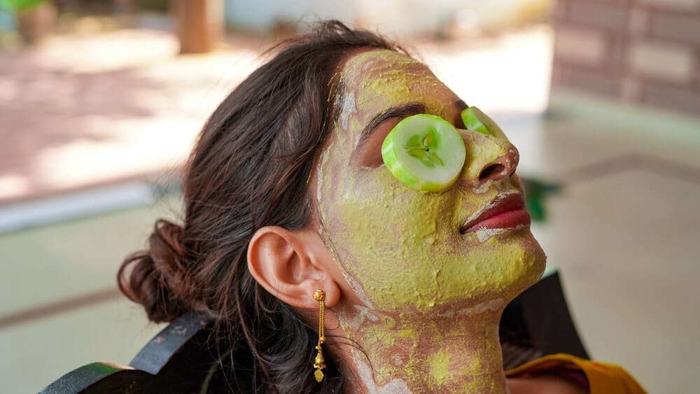 A woman indulging in self-care and skincare with homemade banana face mask.
