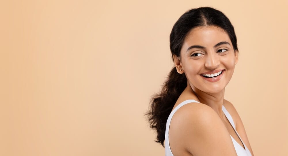 A woman enjoying healthy and beautiful skin as a result of skin treatments.