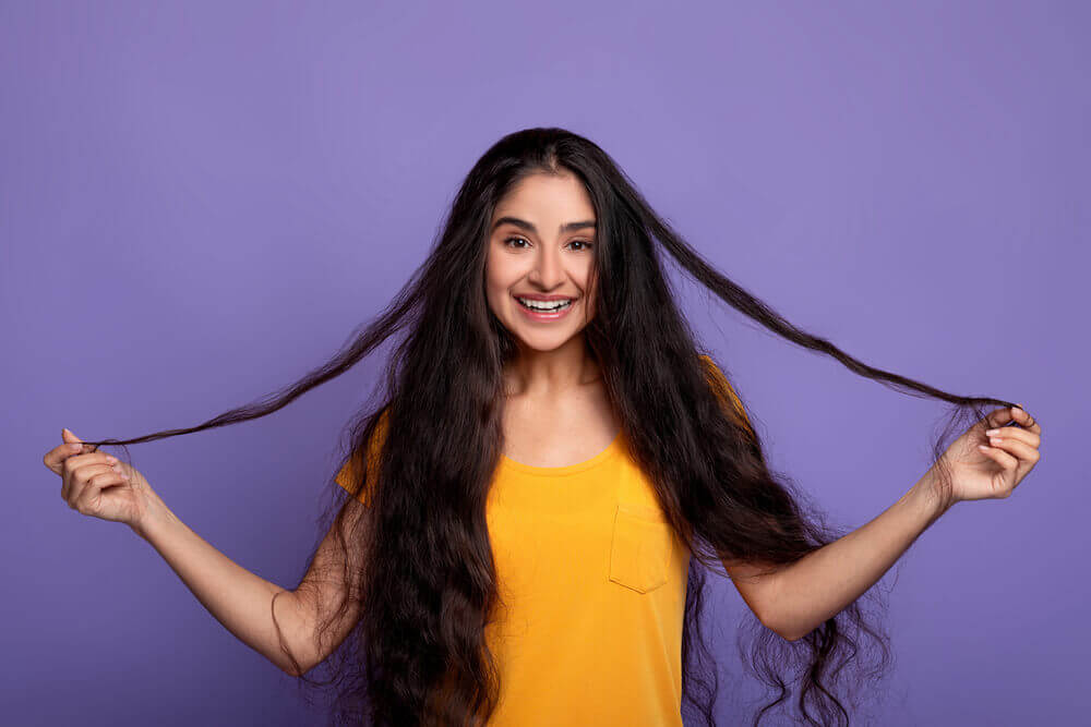 A woman adorning long and healthy hair achieved through hair spa treatments.