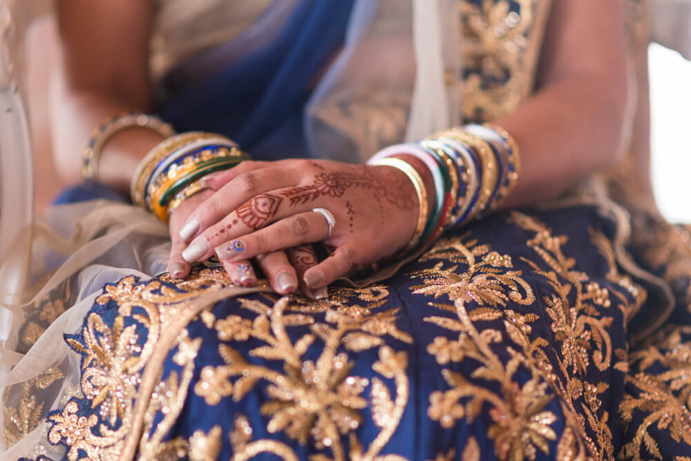 A bride adorning a simple and minimalistic mehendi design on her special day.