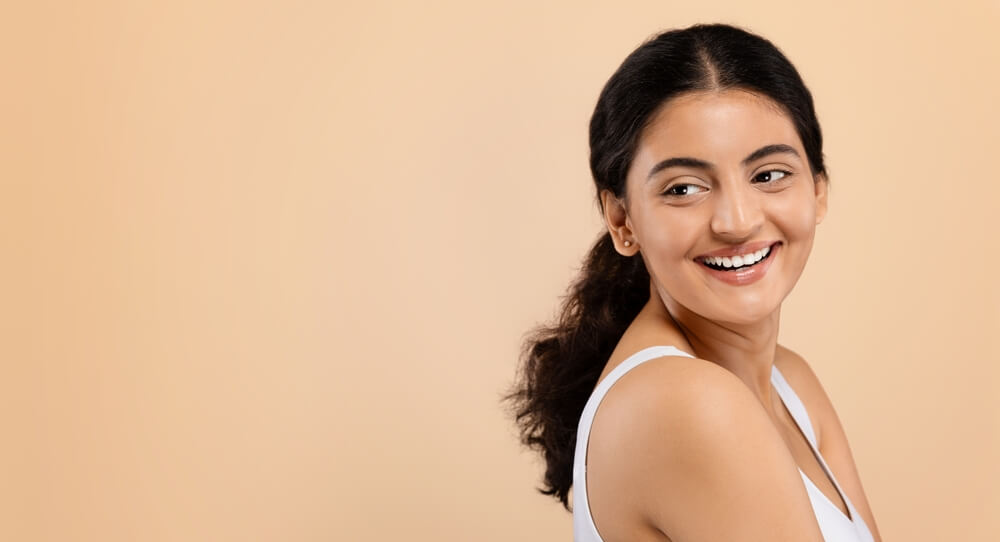 A woman enjoying healthy and beautiful skin as a result of skin treatments.