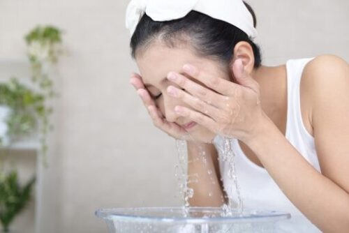 woman washing her face
